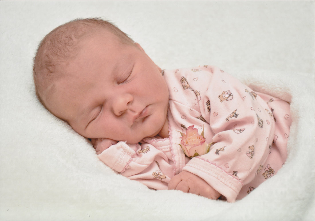 Photo of a newborn baby in a warm blanket
